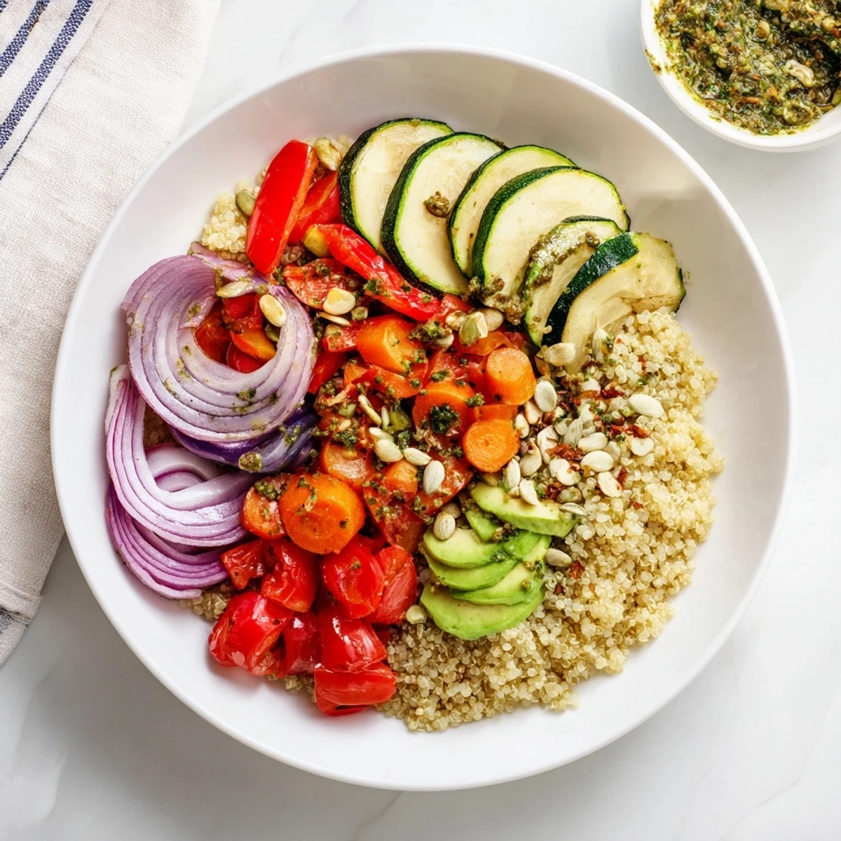 A beautifully plated quinoa bowl: tender roasted veggies, dressed with a bright herb vinaigrette, ready to eat.