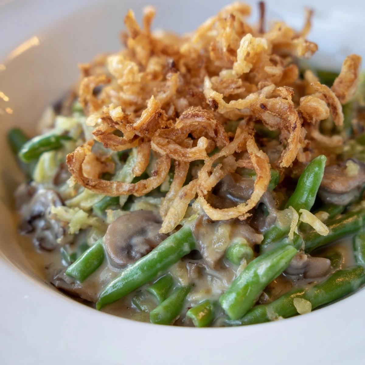 Golden-brown Old-School Green Bean Casserole topped with crispy onions, a comforting classic.
