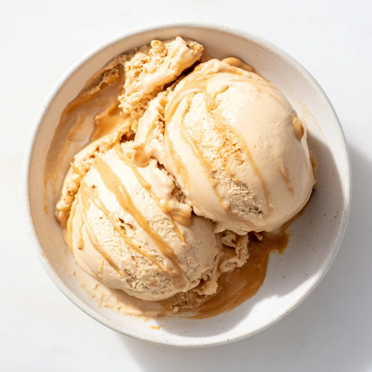 Creamy Peanut Butter Banana Ice Cream swirled in a bowl, ready to enjoy as a refreshing dairy-free treat.