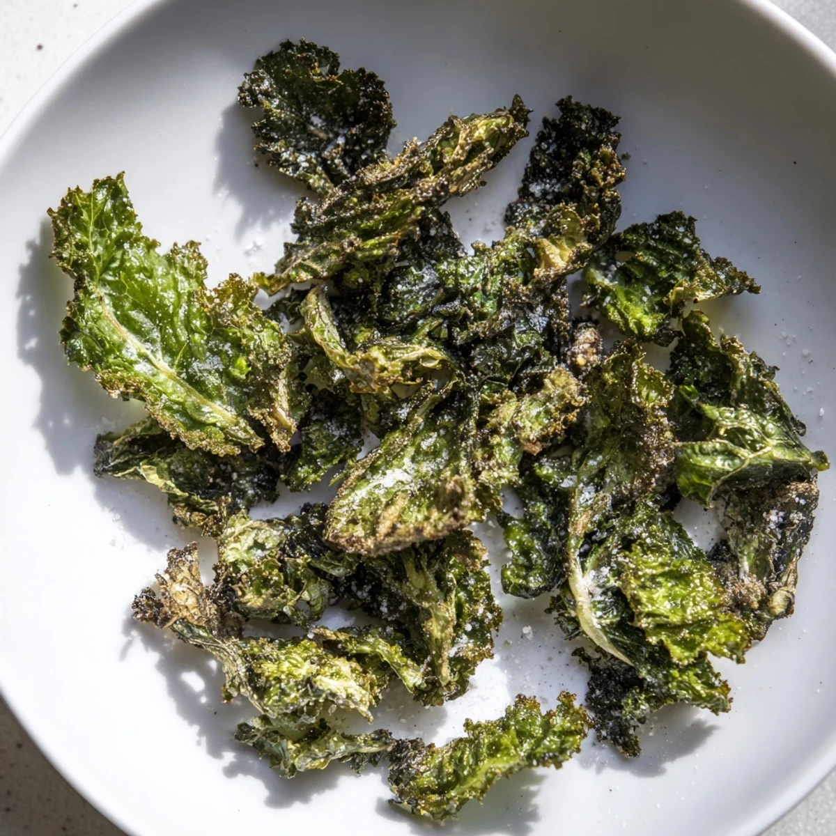 A close-up view of crispy, homemade baked kale chips—the light, healthy snack, ready to eat!