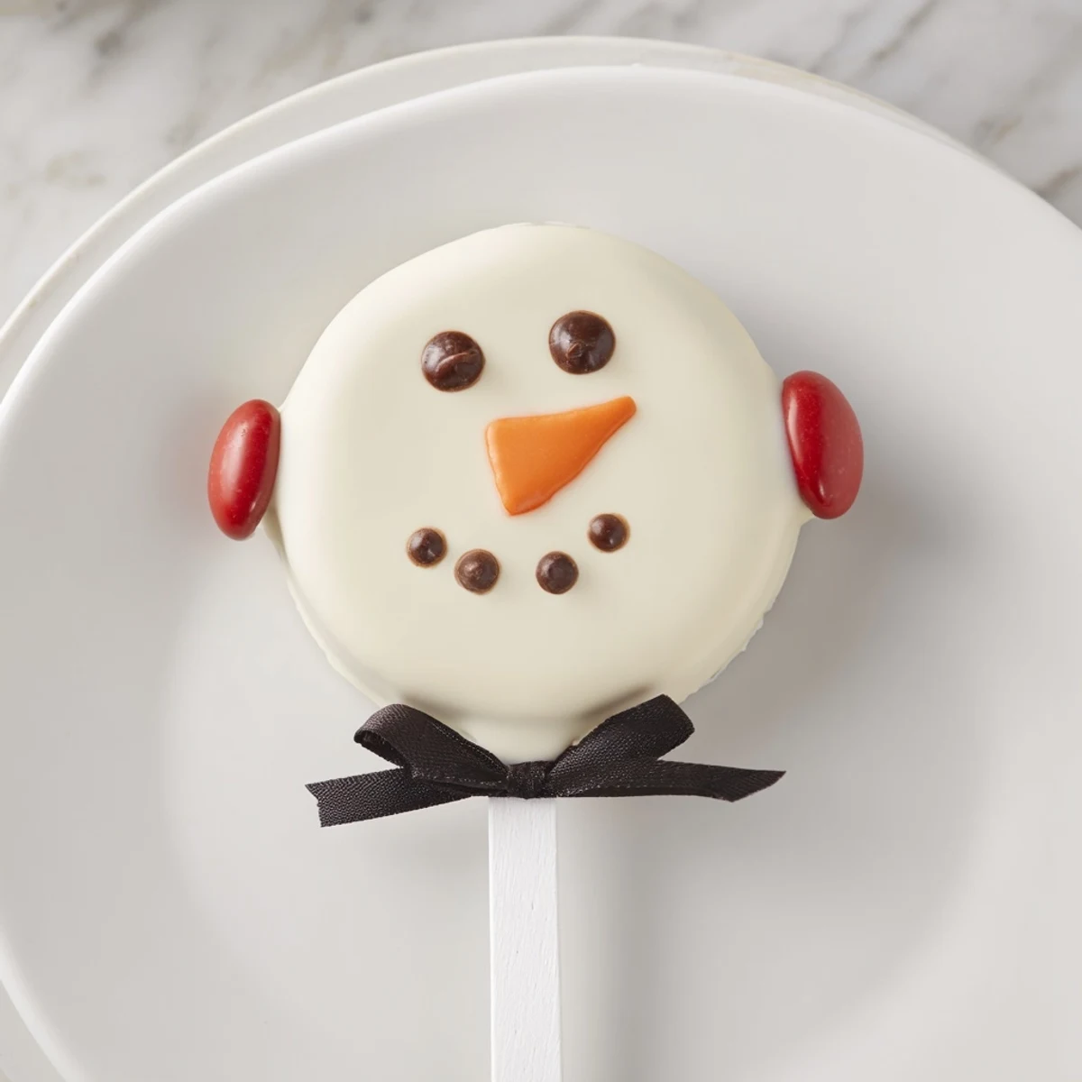 These creamy Budget-Friendly Oreo Snowman Pops feature perfectly dipped, decorated Oreos, ready to enjoy.