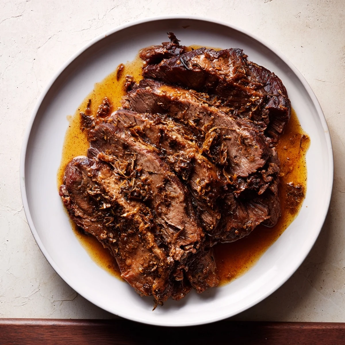 Tender Budget Holiday Chuck Roast, falling apart and ready to serve with rich, savory pan juices.