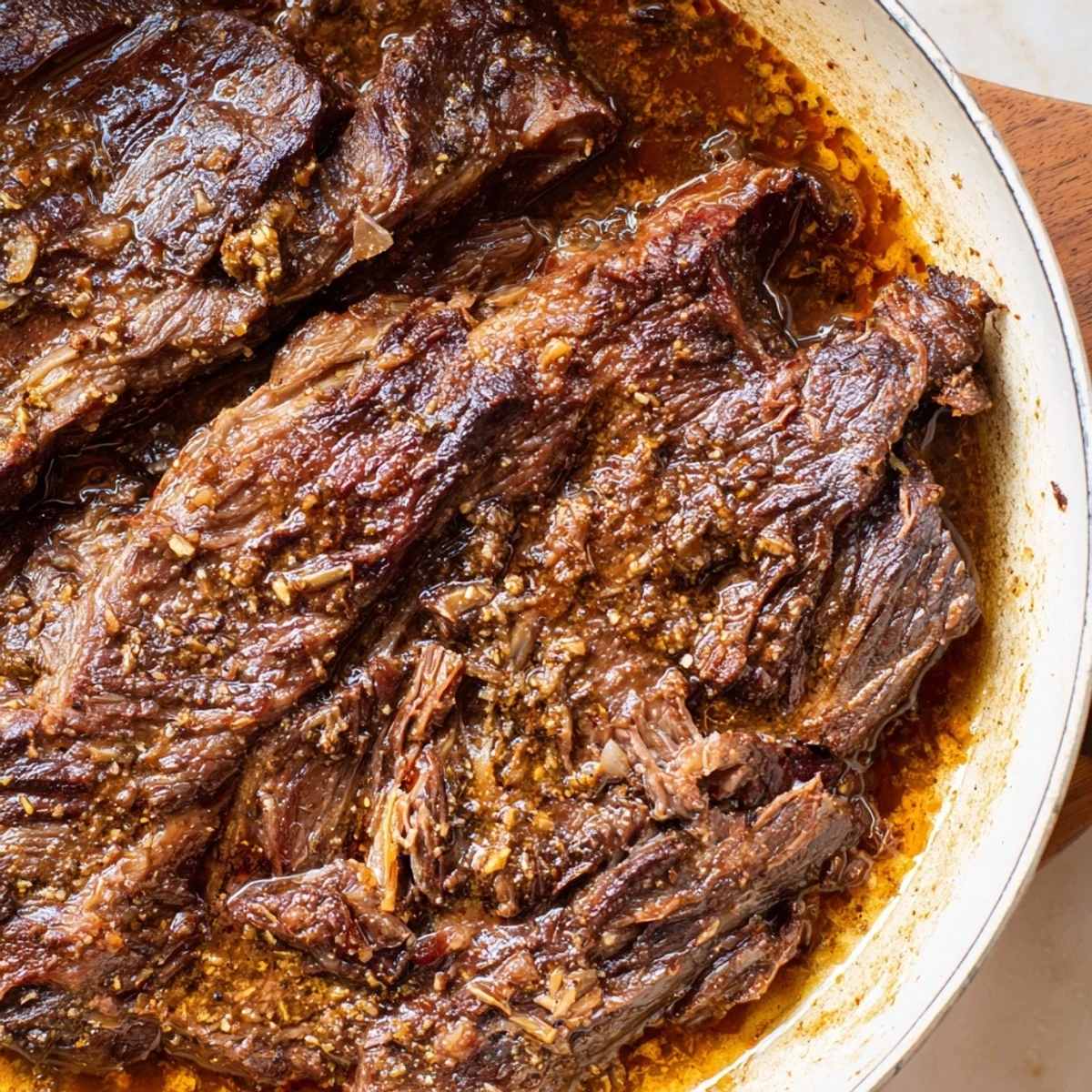 A Dutch oven brimming with a Budget Holiday Chuck Roast, seasoned and roasted to perfection for a holiday meal.
