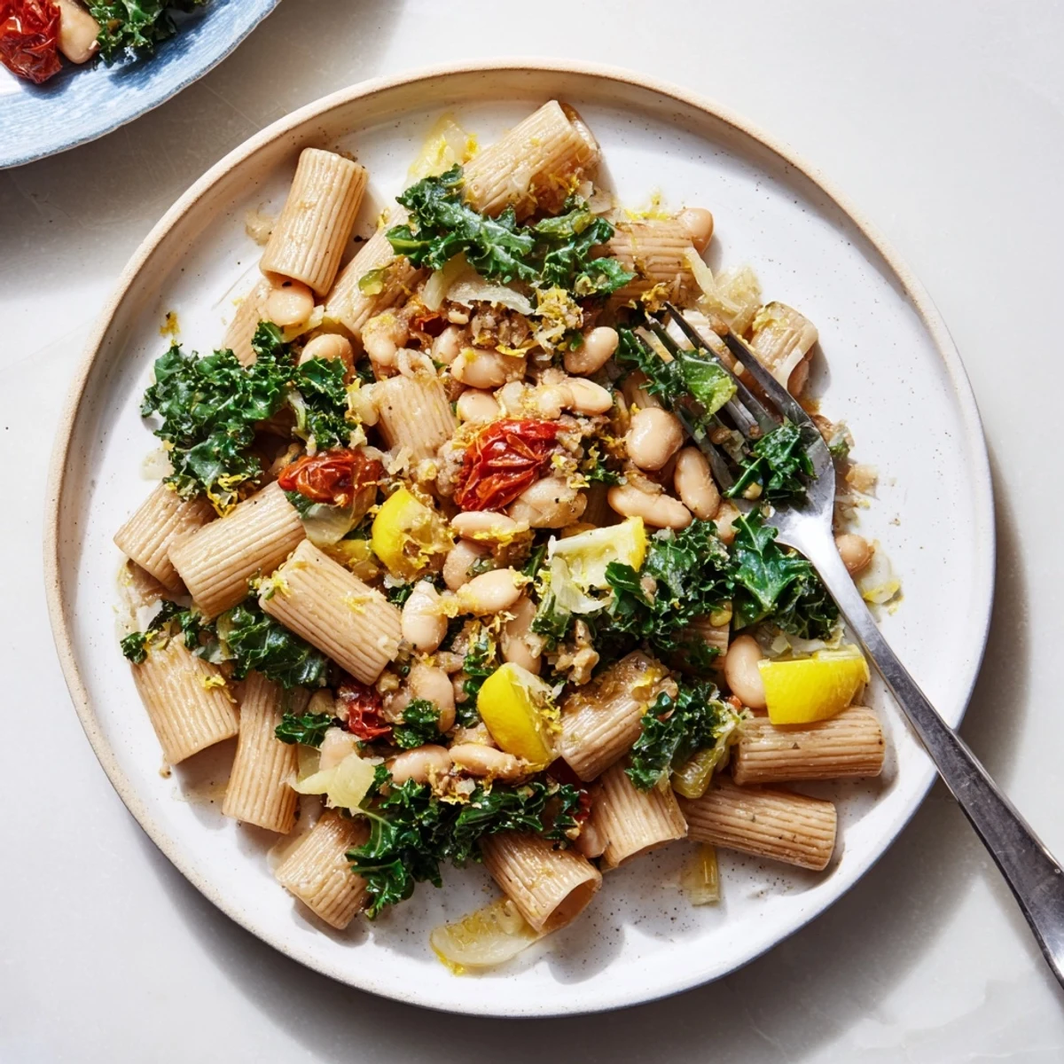 Delicious, creamy Healthy Tuscan White Bean & Kale Christmas Pasta with fresh kale and tomatoes, ready to serve.