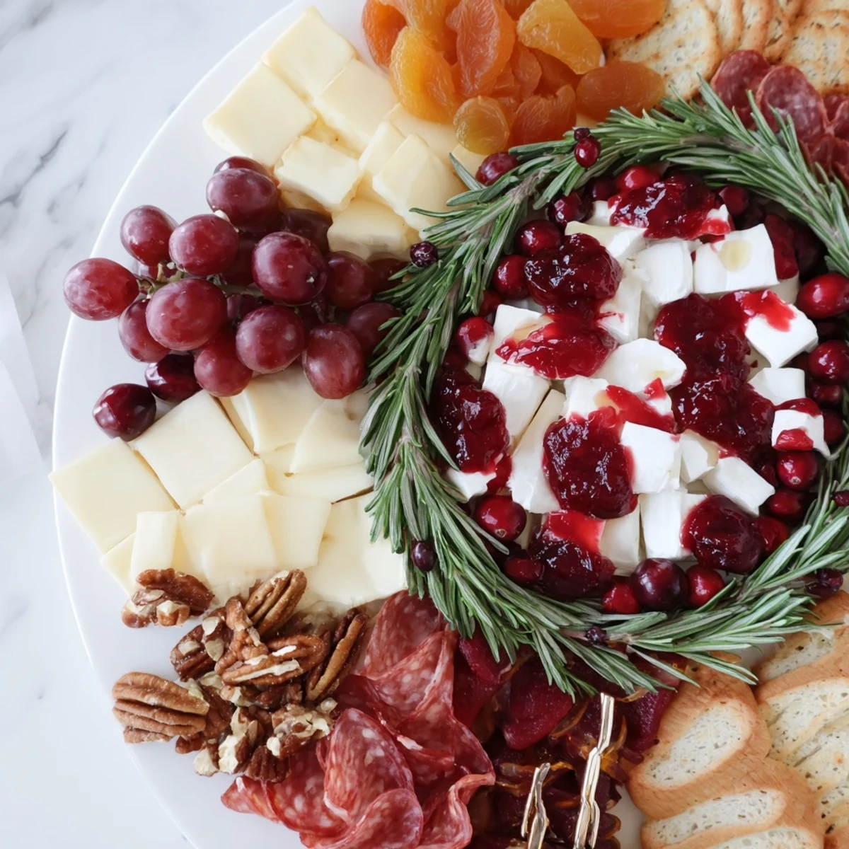 Vibrant Cranberry Wreath Platter with creamy cheeses, fresh fruit, and savory meats for a perfect holiday appetizer.