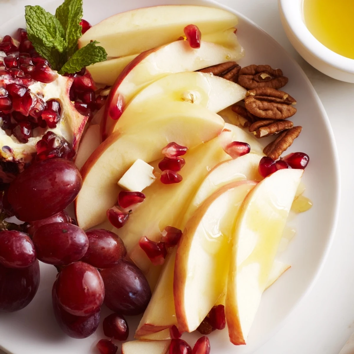 Apple Orchard Fruit Board overflowing with crisp apples, grapes, and a drizzle of honey, ready to serve.