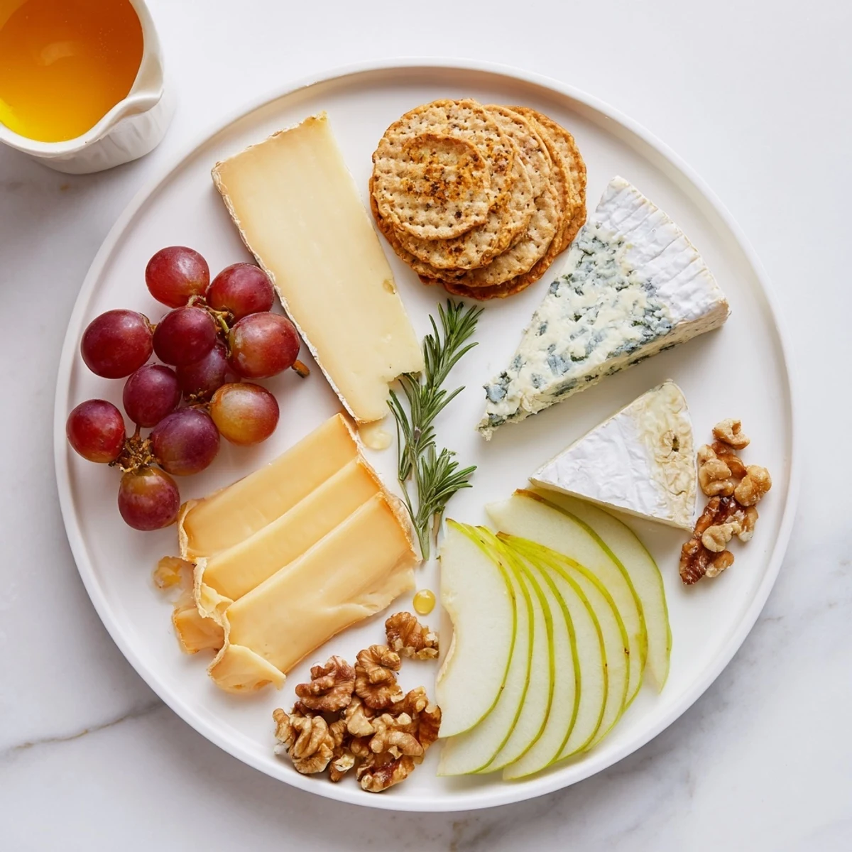 A beautiful cheese plate with Brie, cheddar, grapes, and cracker rings ready to enjoy.