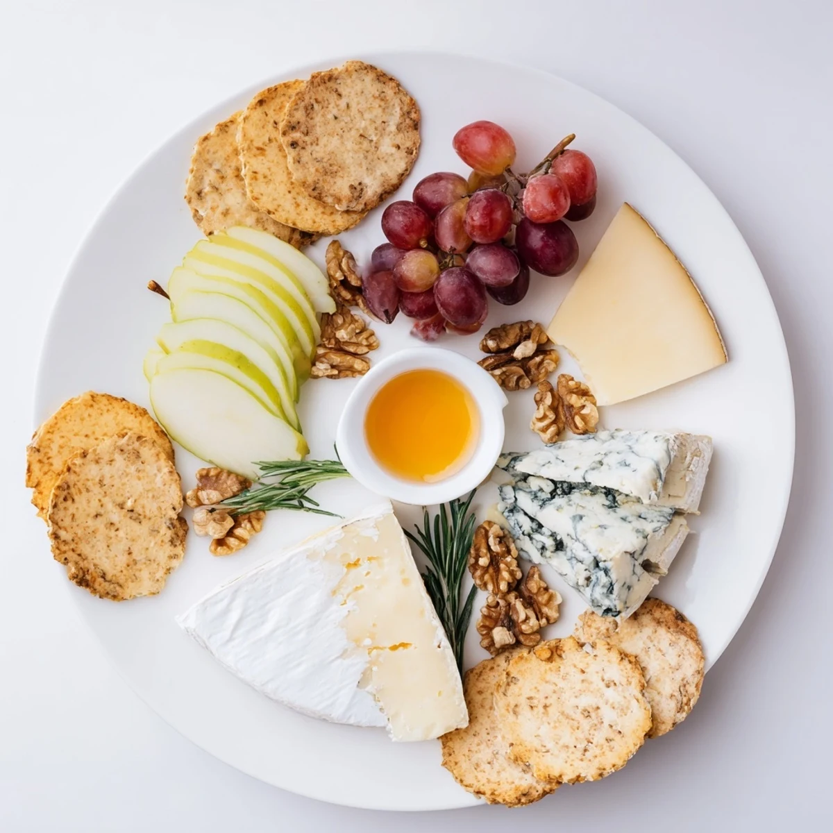 Delectable cheese plate appetizer featuring creamy brie, aged cheddar, and assorted fruits and crackers.