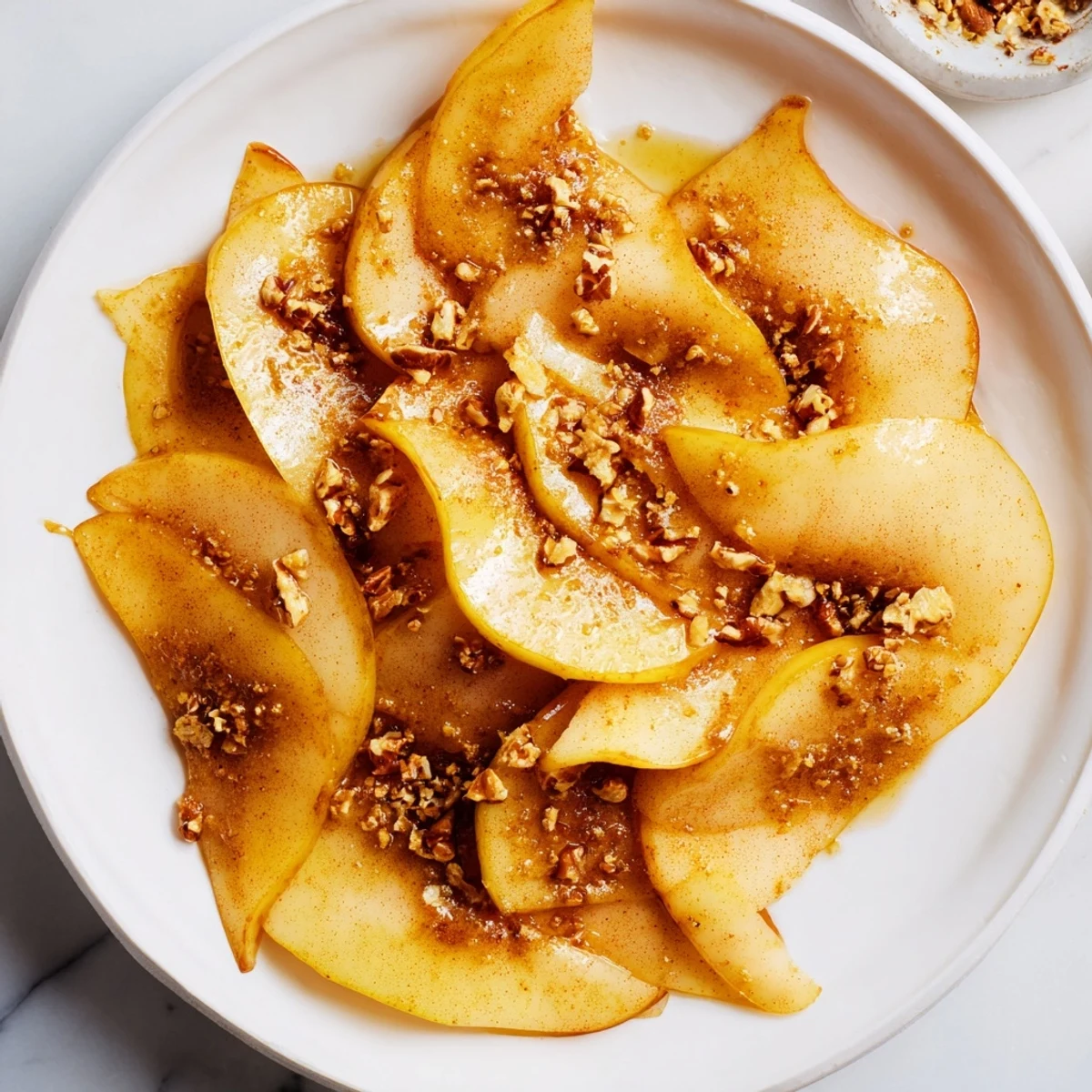 Fresh pear slices with golden honey drizzle, a simple yet elegant dessert for two.