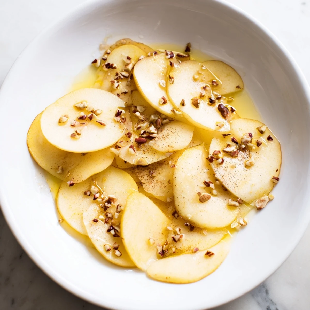 Sweet, juicy pear slices, artfully drizzled with honey, ready to eat for a light, refreshing treat.