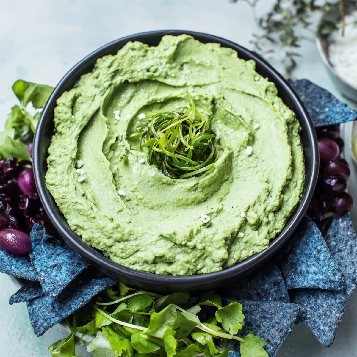 A bubbling Witch's Brew in a black cauldron, ready to be served with tortilla chips for dipping.