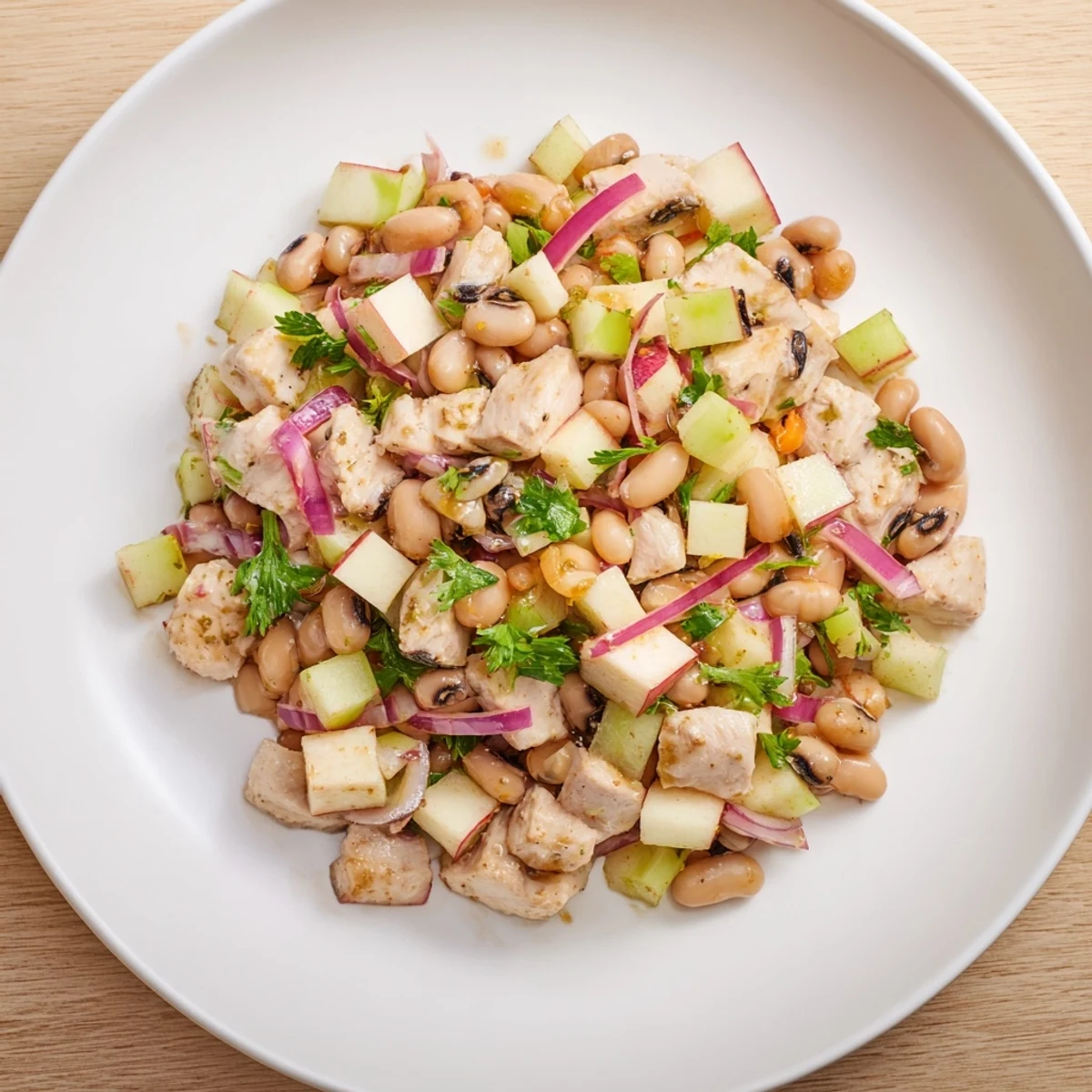 Enjoy a celebratory Chicken and Apple New Years Luck Salad; a beautiful, light bite with a honey-mustard dressing.
