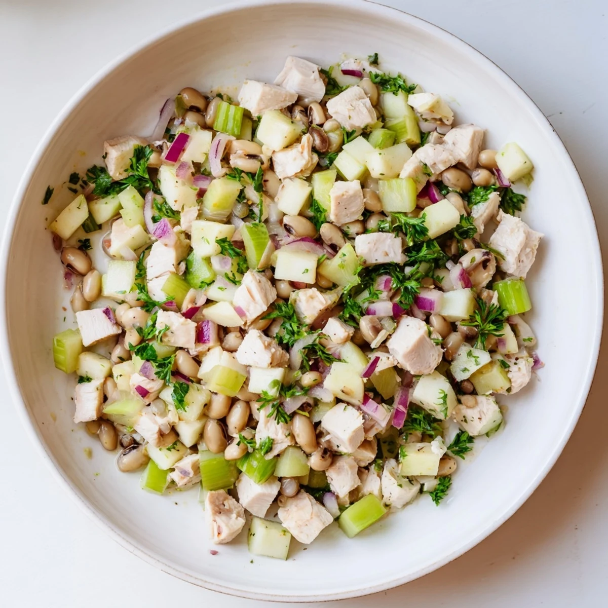 This refreshing Chicken and Apple New Years Luck Salad features bright red apple pieces alongside tender chicken.