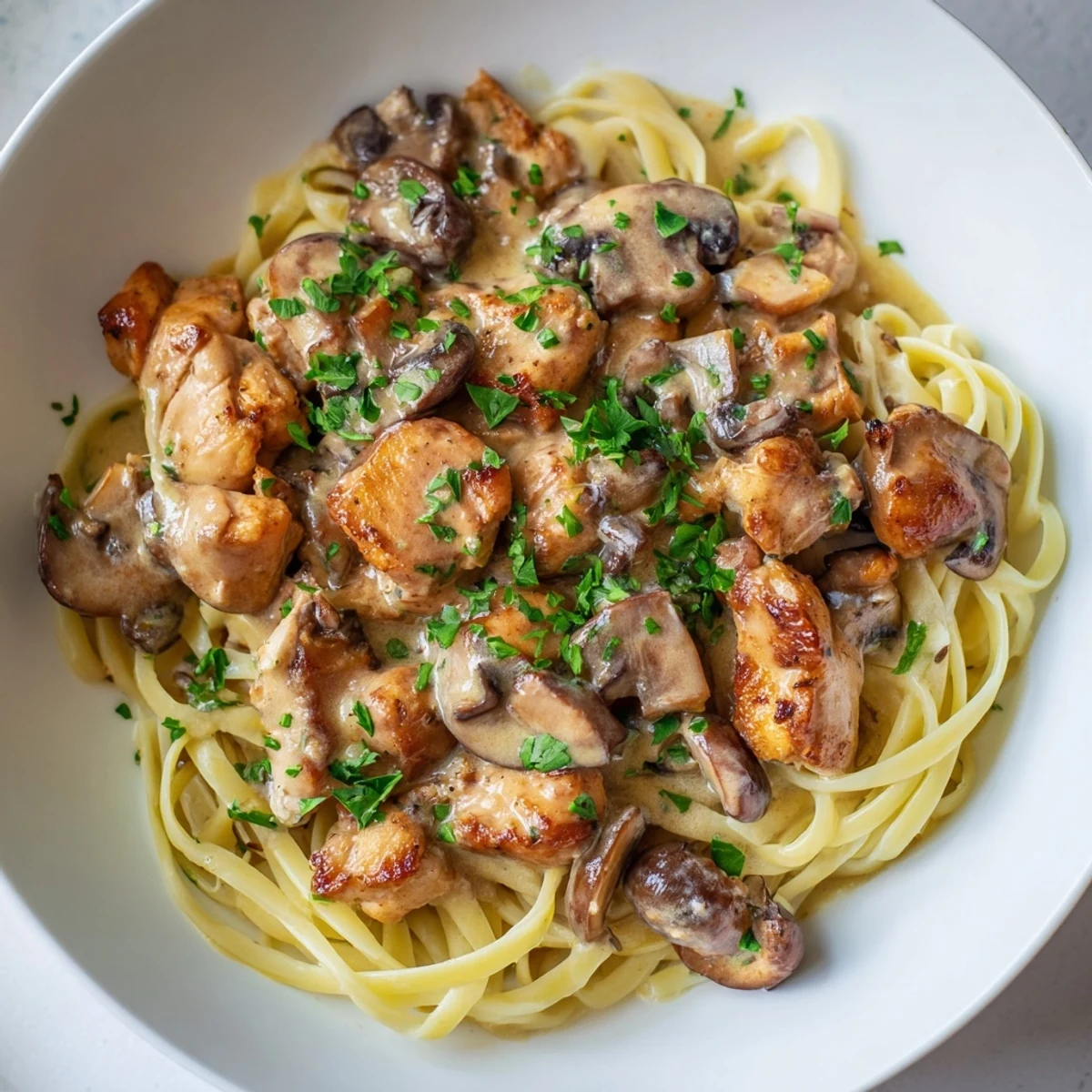 Golden chicken pieces and creamy mushroom chicken pasta, ready to serve and enjoy this comforting meal!