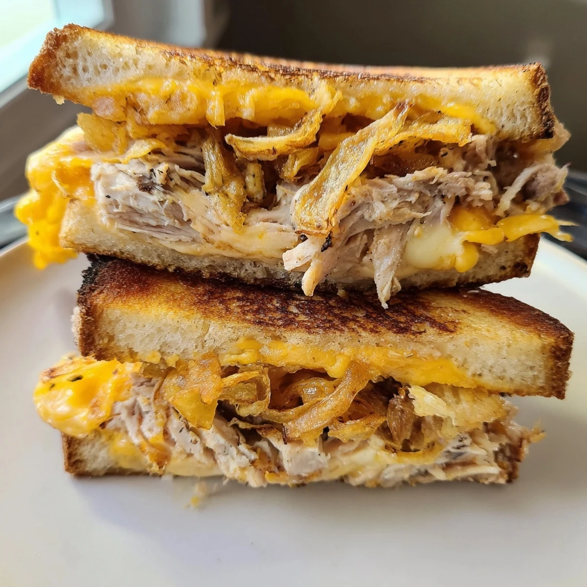 Golden-brown Crispy Shallot Chicken Grilled Cheese sandwich with melted cheese, ready to eat.