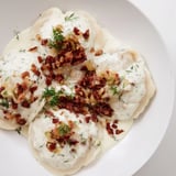 Close-up of golden-brown Cepelinai, showing the potato dumpling contrasted with rich meat filling.