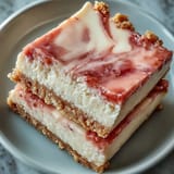 A tropical guava cheesecake with a tangy marmalade swirl baked on a crisp Maria cookie crust, perfect for summer dessert.