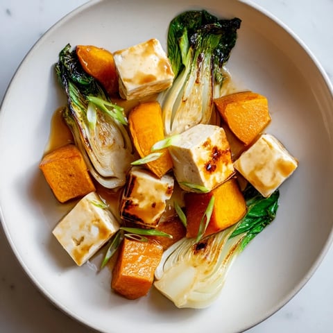 Appearance of glistening miso-glazed tofu and winter squash alongside tender bok choy.