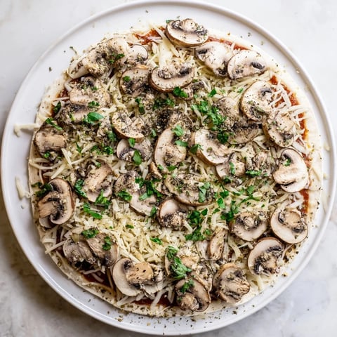 Golden, bubbly, cheesy Frozen Pizza Upgrade with roasted mushrooms and herbs, a perfect dinner!