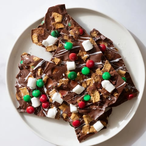 Quick Christmas Smores Bark: A close-up of festive candy bark with marshmallows and sprinkled candy pieces.