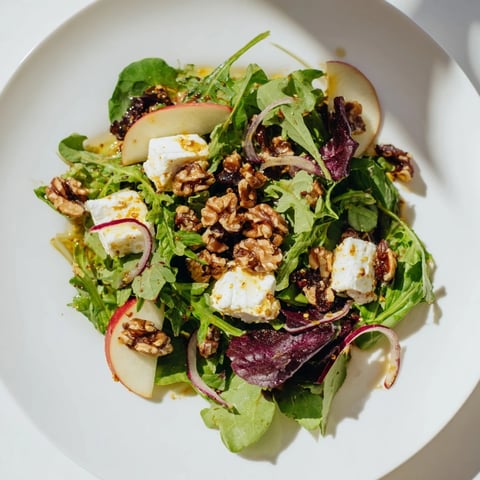 Spiced Honey and Date Goat Cheese Salad displays vibrant greens with creamy goat cheese and sweet dates.