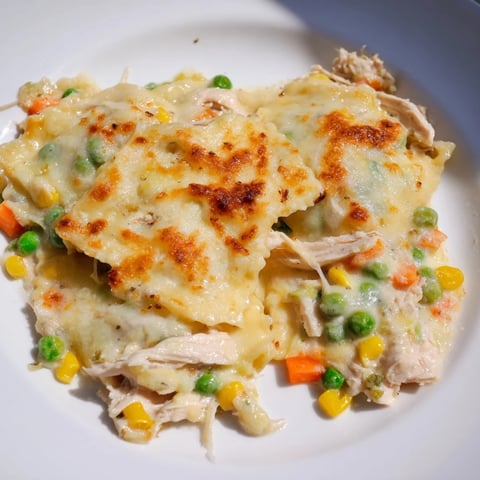 Golden, bubbly Chicken Pot Pie Ravioli Bake with melted cheese and a creamy chicken filling.