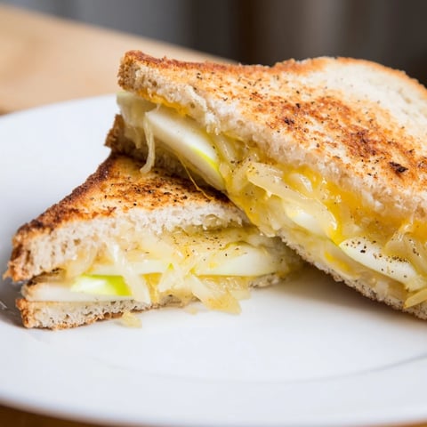 Golden, melty Caramelized Onion, Apple & Cheddar Grilled Cheese sandwich, served warm and delicious.