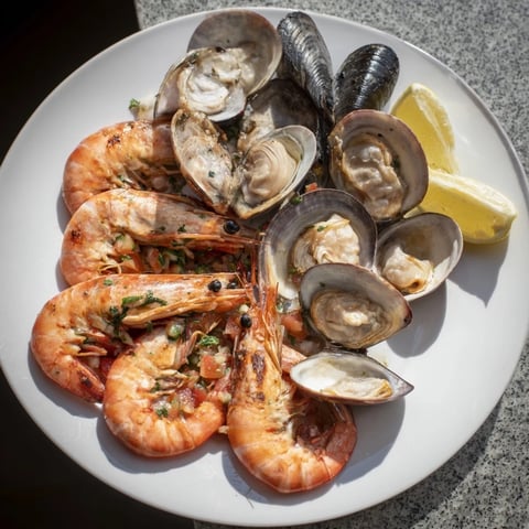 Steaming shellfish and seafood medley, bursting with fresh flavors, perfectly cooked for a light main course.