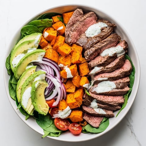 Steaming, tender beef avocado sweet potato bowl with creamy avocado and fresh cilantro, ready to eat.