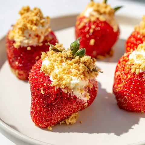 Fresh, juicy Cheesecake Stuffed Strawberries, a perfect bite of creamy cheesecake inside a red berry.