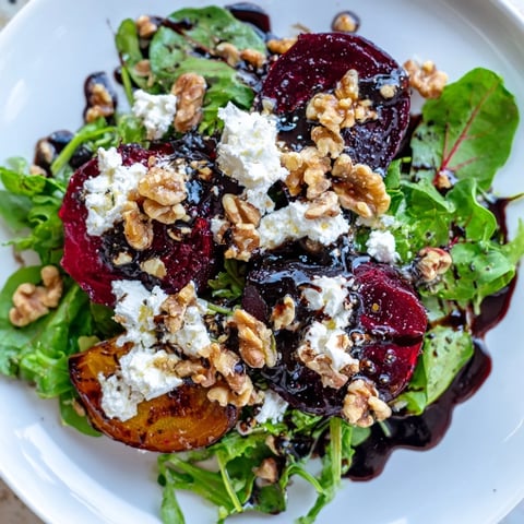 Roasted beet and goat cheese salad, with vivid red beets, creamy cheese, and a tangy dressing.