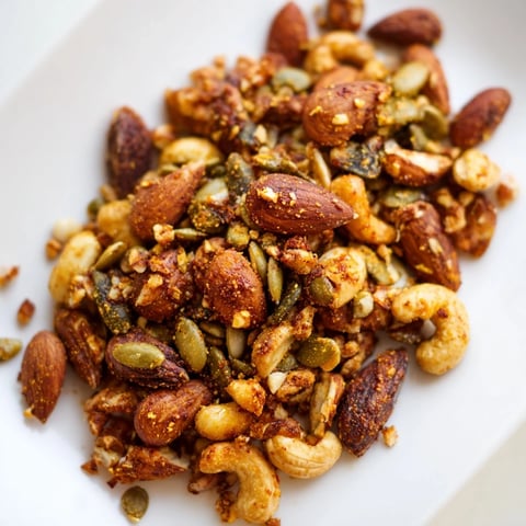 Golden brown Spiced Nuts and Seeds Mix ready to enjoy as a healthy crunchy snack.