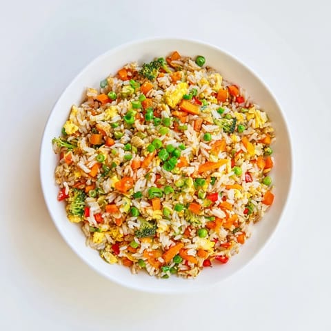This Veggie-Packed Fried Rice image displays a steaming skillet full of colorful, flavorful goodness.