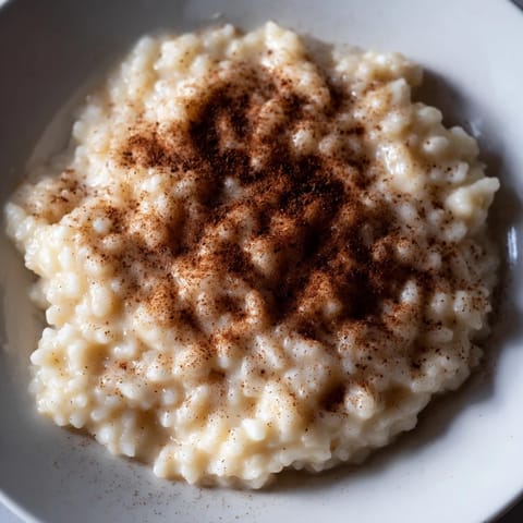 Steaming hot Rice Pudding with Leftover Rice, perfectly thickened and fragrant, ready to enjoy.