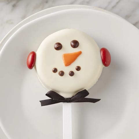 These creamy Budget-Friendly Oreo Snowman Pops feature perfectly dipped, decorated Oreos, ready to enjoy.