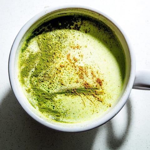 View an image of a frothy Coconut Ginger Matcha Winter Immunity Latte, perfect for a cold day's boost.
