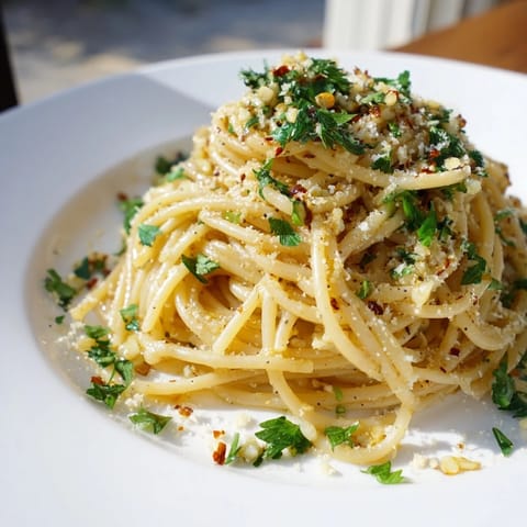 A close-up of Garlic Butter Noodles showcasing the glistening butter, garlic, and fresh pasta.