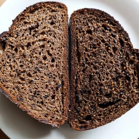 Warm, freshly baked Estonian Leib Sourdough with a beautiful, rich, brown crust; perfect with butter.