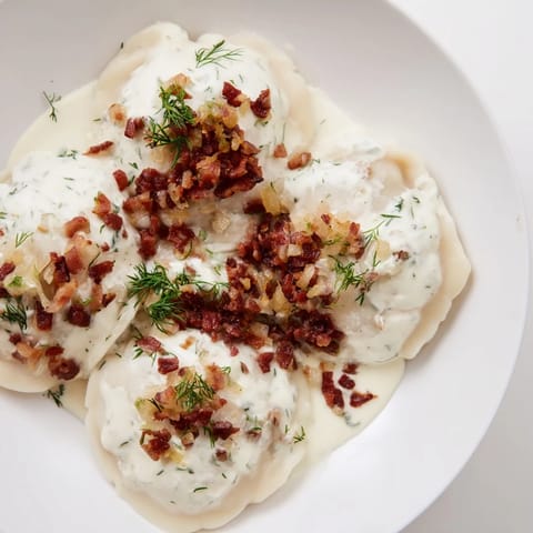 Close-up of golden-brown Cepelinai, showing the potato dumpling contrasted with rich meat filling.