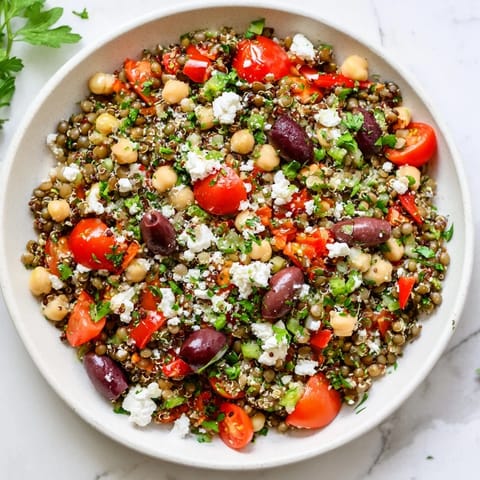 Close-up of Greek Power Salad featuring cherry tomatoes, cucumbers, olives, and crumbled feta cheese for a Mediterranean lunch.