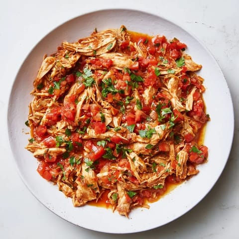 Steaming Crock-Pot Shredded Chicken Tacos, piled high with colorful toppings, ready to enjoy.