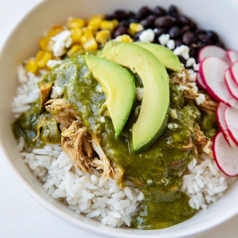 Flavorful Green Enchiladas Rice Bowl, a gluten-free meal with warm spiced chicken and black beans.