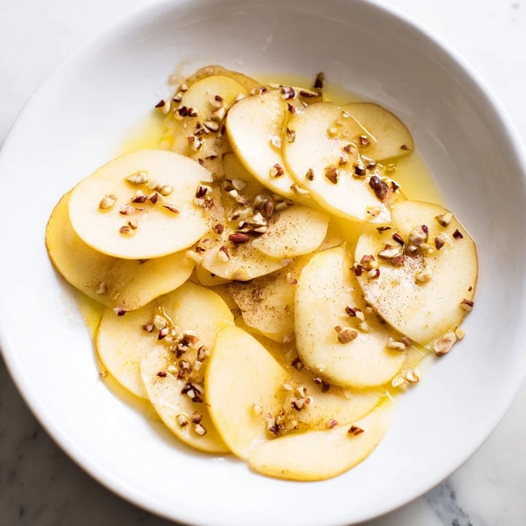 Sweet, juicy pear slices, artfully drizzled with honey, ready to eat for a light, refreshing treat.