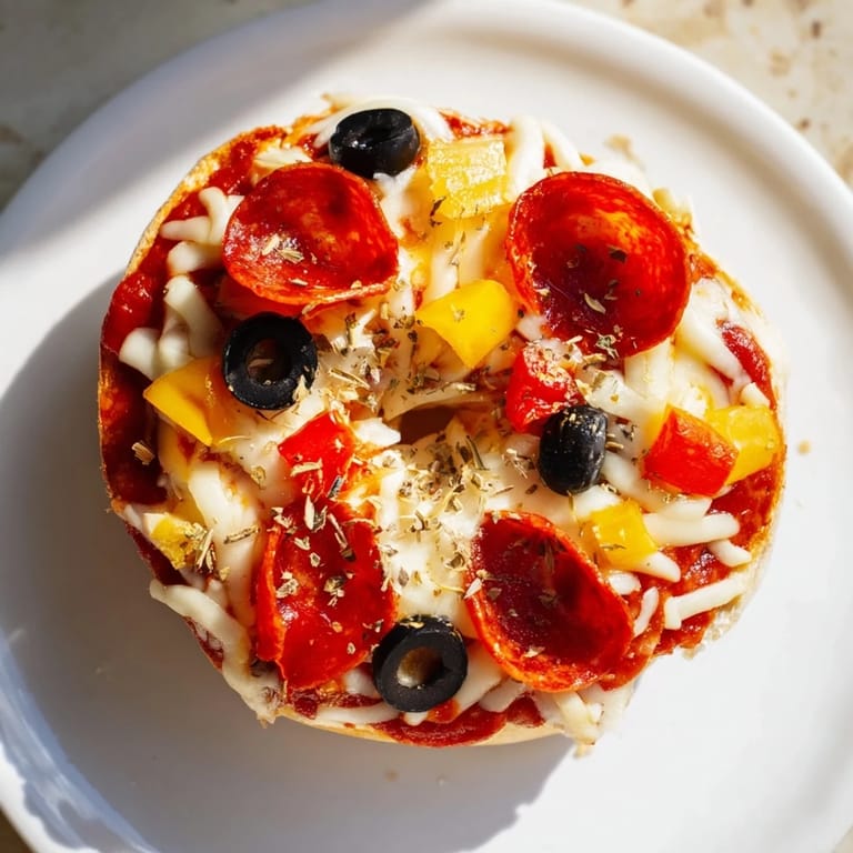 Air-fried mini bagel pizzas with melted cheese and crispy pepperoni, a perfect snack or appetizer.