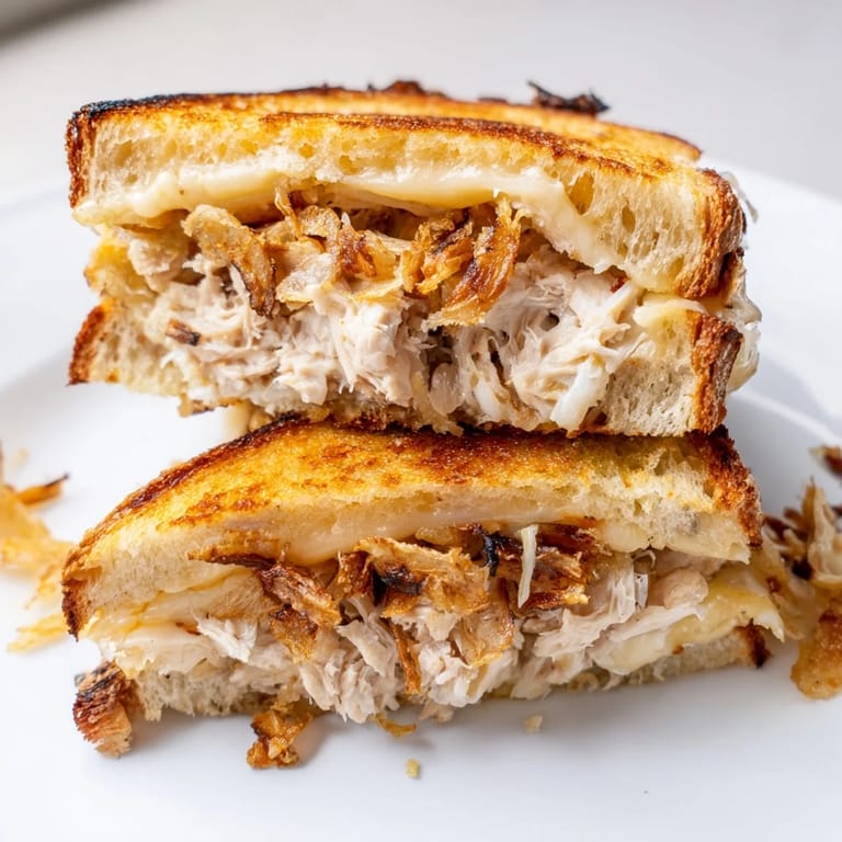 Close-up of a perfectly grilled Crispy Shallot Chicken Grilled Cheese, showing the crispy texture.