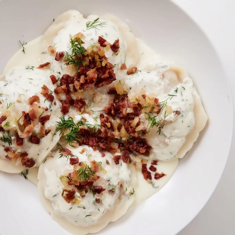 Close-up of golden-brown Cepelinai, showing the potato dumpling contrasted with rich meat filling.