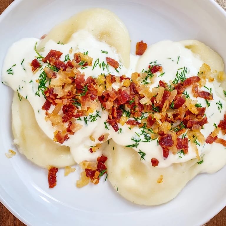 A delicious bite of Lithuanian Cepelinai sits fork-ready, ready to savor the juicy pork and beef.